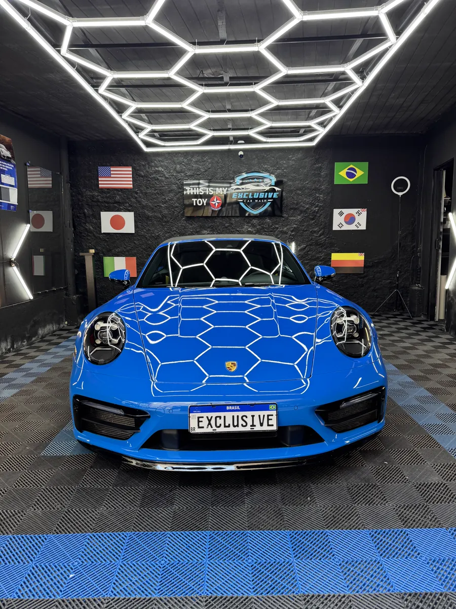 Porsche azul fotografado de frente no estúdio da Exclusive Car